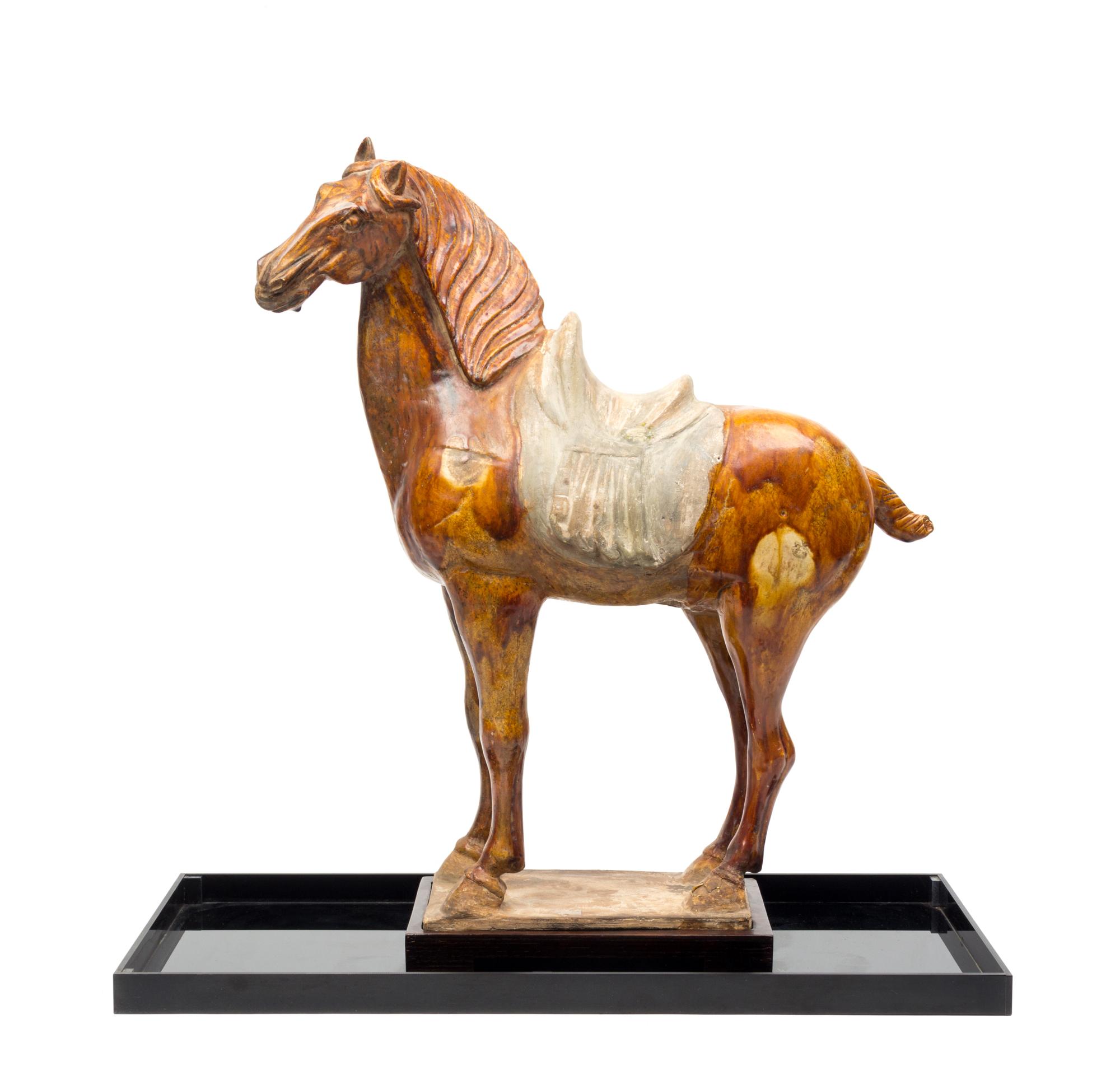 A Straw Glazed Pottery Figure of a Horse Height 21 1/4 inches. — TANG DYNASTY (618-907)
