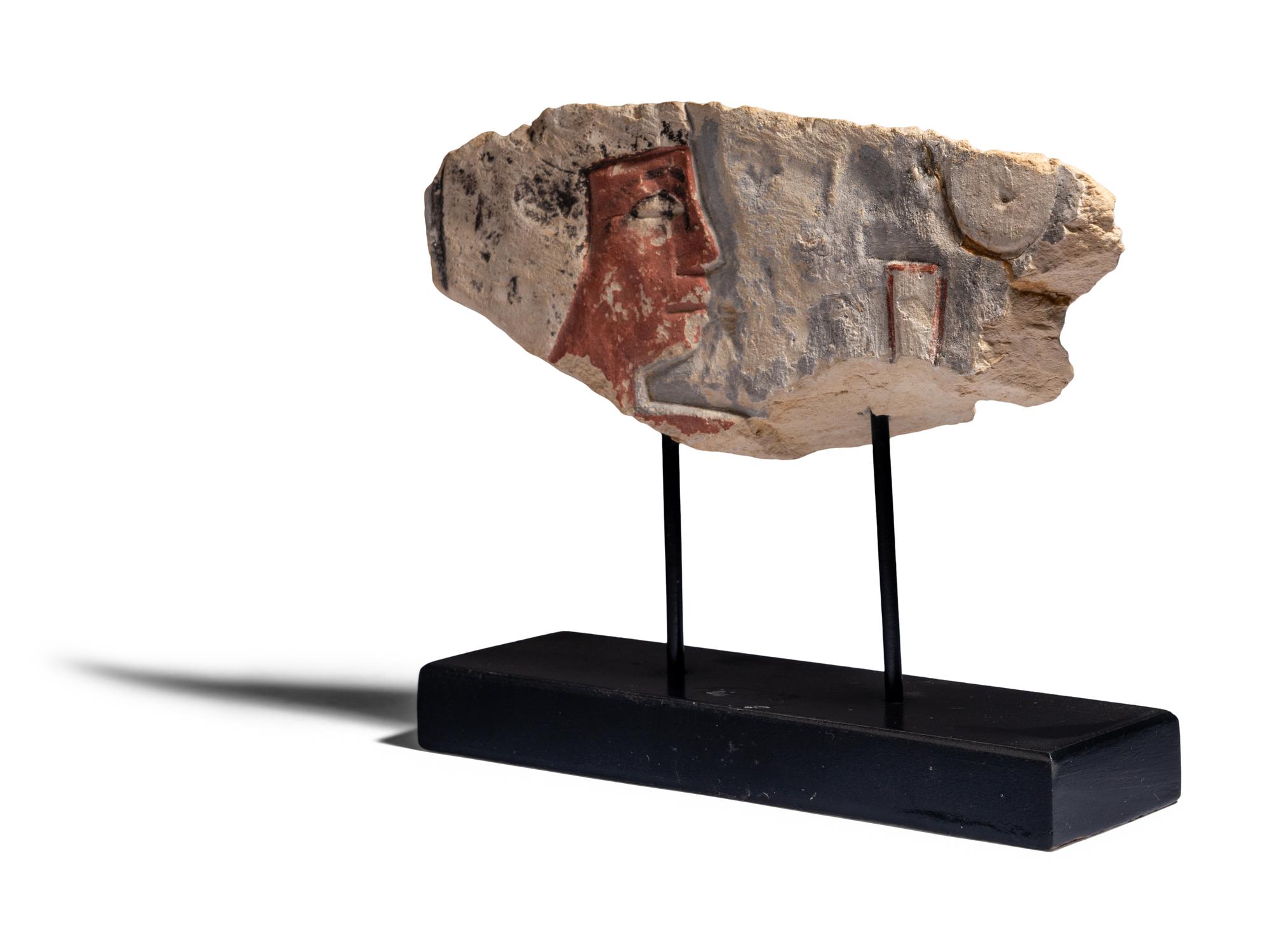 An Egyptian Painted Limestone Relief Fragment