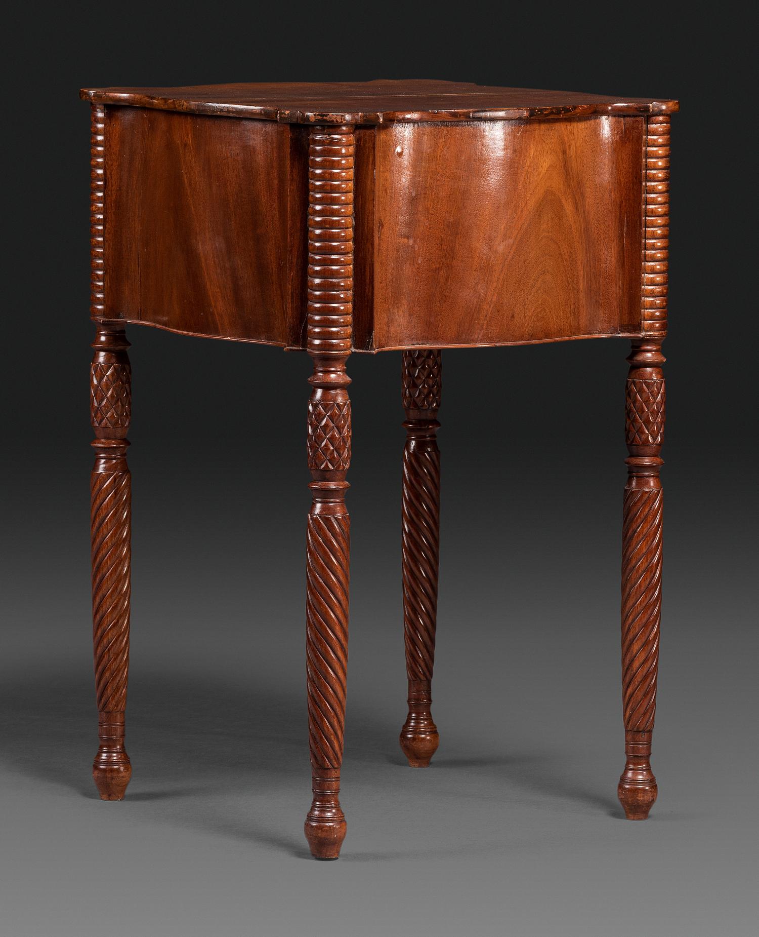 A Classical Carved Mahogany Three Drawer Work Table