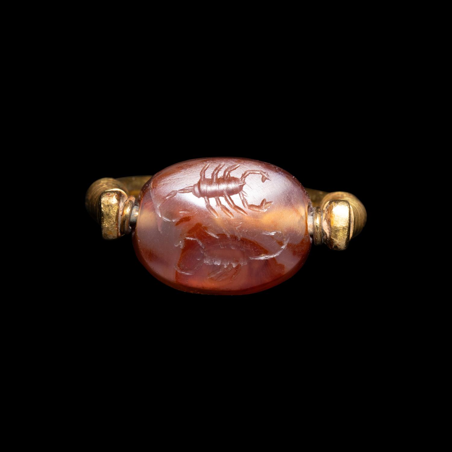 A Phoenician or Cypriot Gold and Carnelian Swivel Ring with Two Scorpions