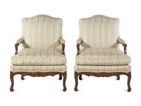 A Pair of Louis XV Style Carved Walnut Fauteuils