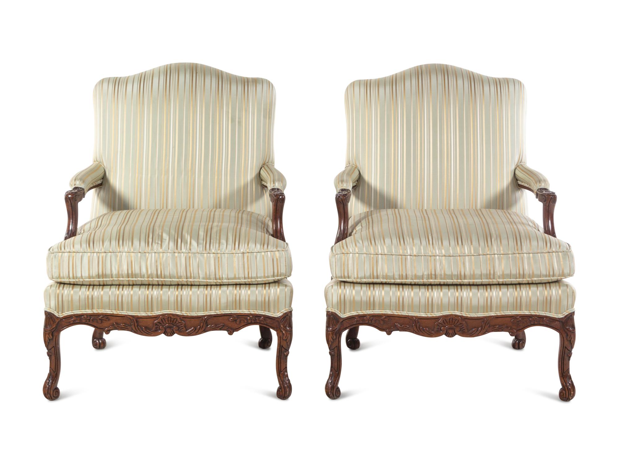 A Pair of Louis XV Style Carved Walnut Fauteuils