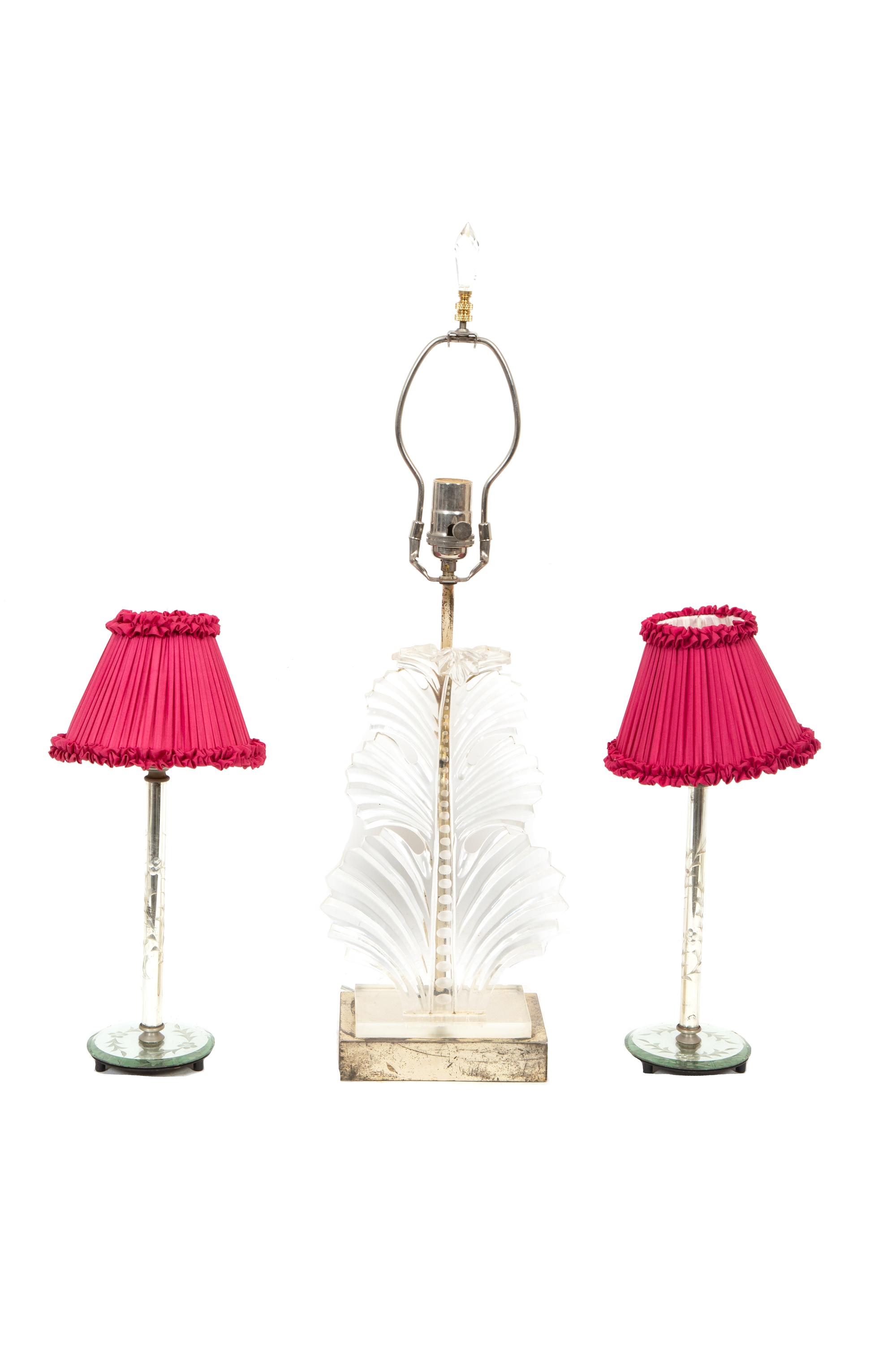 A Group of Decorative Table Articles comprising a pair of candlestick lamps, and an acrylic shell motif lamp.