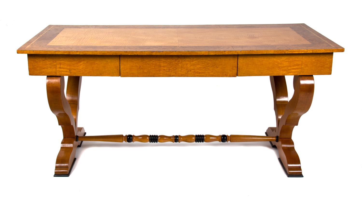 A Biedermeier Birch and Burlwood Writing Table Height 29 3/4 x width 66 x depth 29 1/2 inches. — 19TH CENTURY
