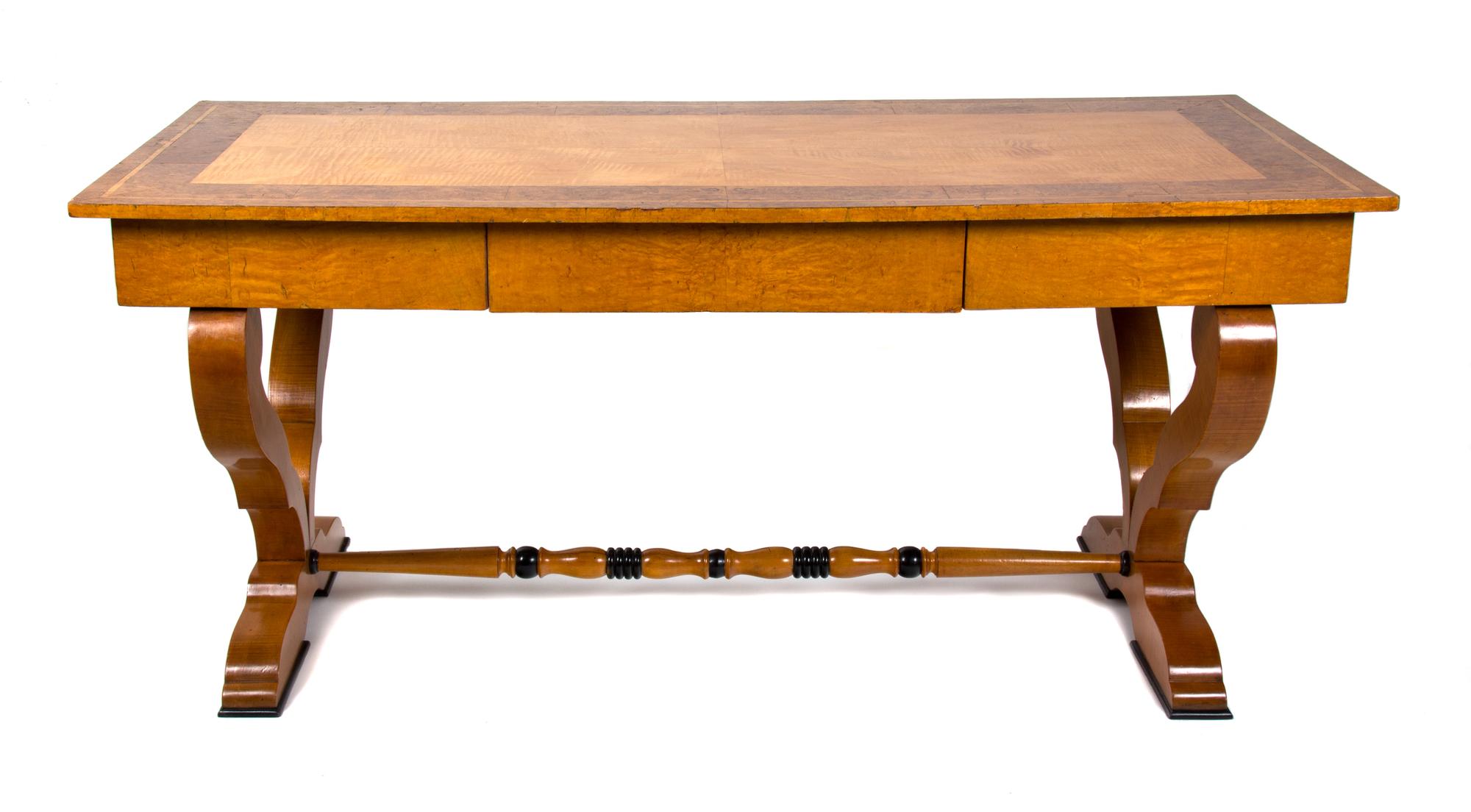 A Biedermeier Birch and Burlwood Writing Table Height 29 3/4 x width 66 x depth 29 1/2 inches. — 19TH CENTURY