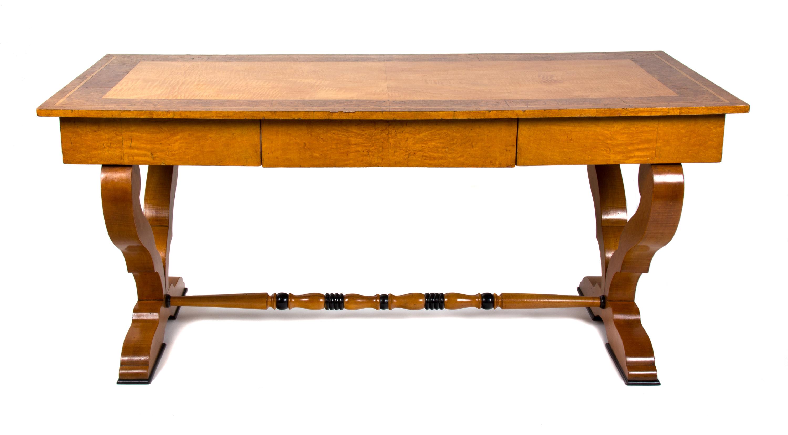 A Biedermeier Birch and Burlwood Writing Table Height 29 3/4 x width 66 x depth 29 1/2 inches. — 19TH CENTURY