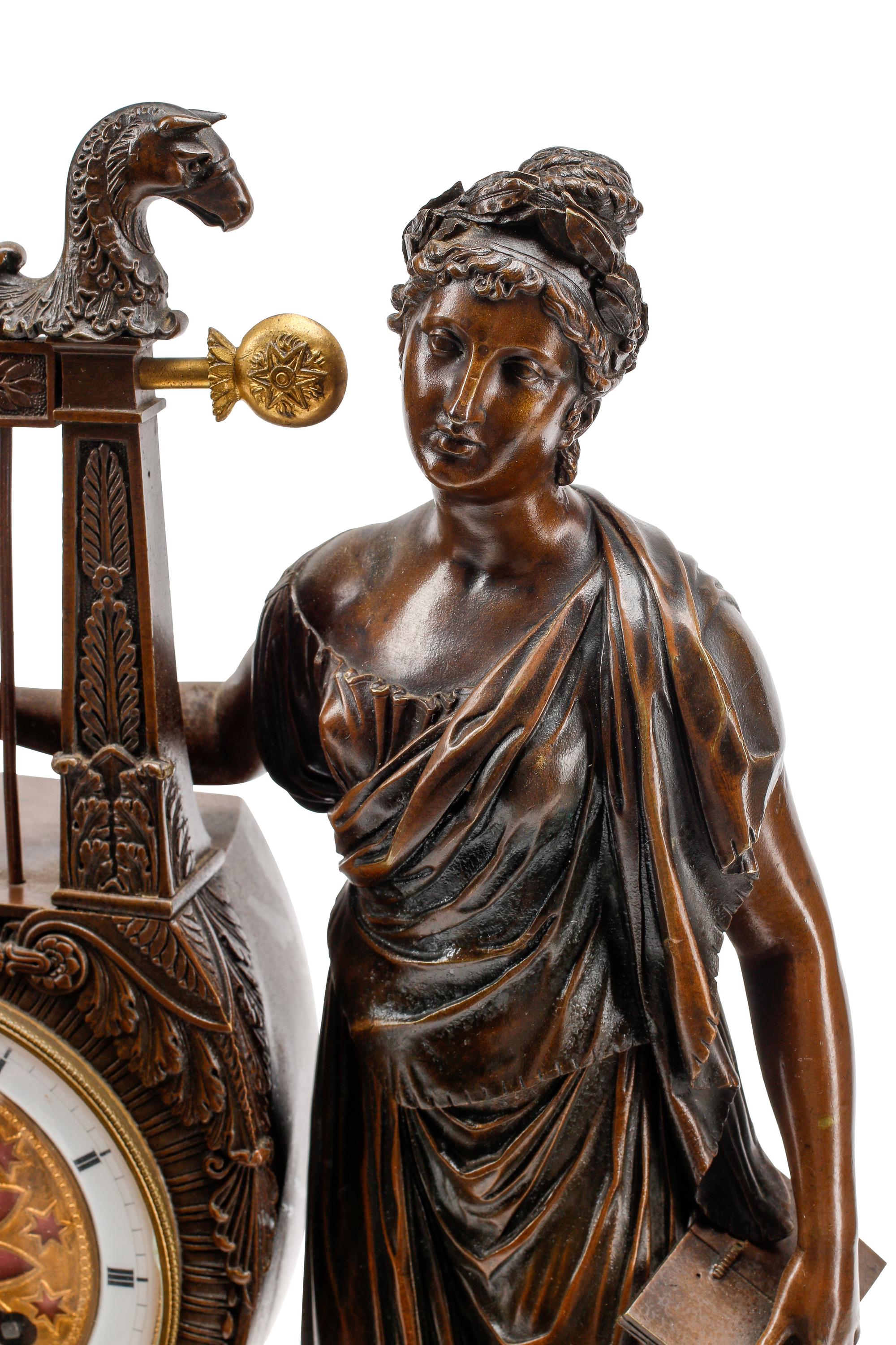 An Empire Style Gilt and Patinated Three-Piece Clock Garniture