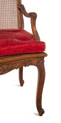 A Pair of Régence Style Carved Walnut and Caned Fauteuils à la Reine