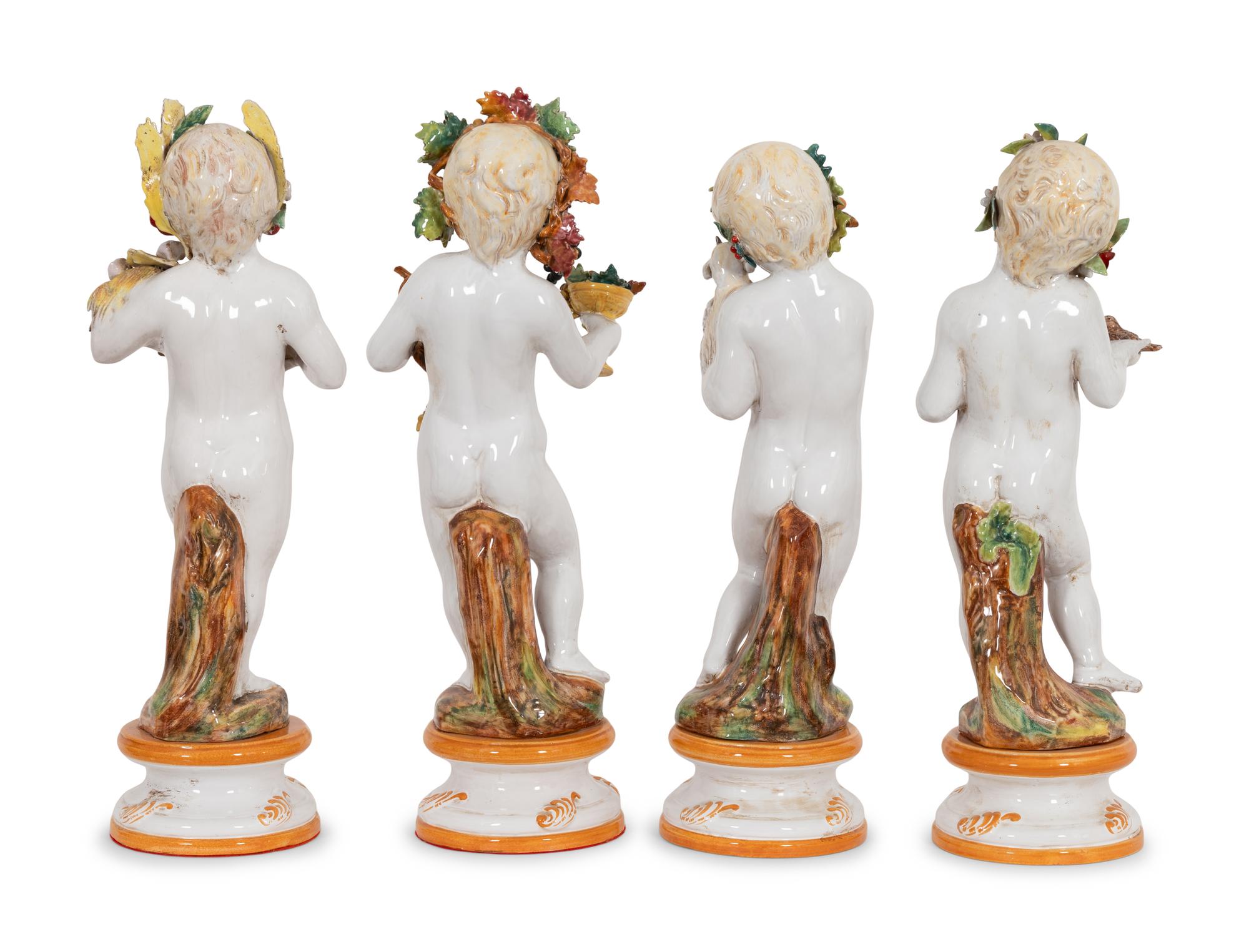 A Set of Large Italian Majolica Four Seasons Putti Figures