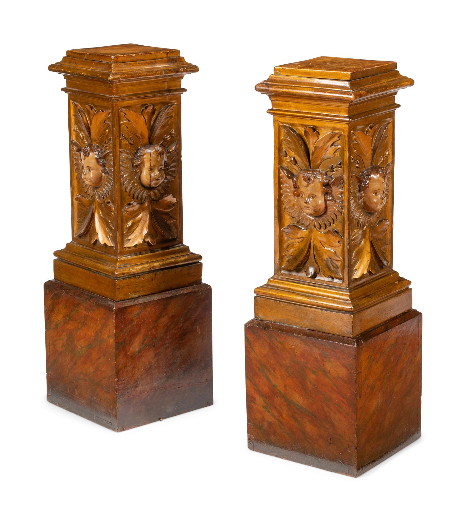 A Pair of Continental Faux Marble Painted and Gilt Pedestals with Putto Masks