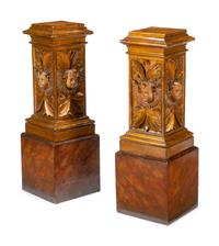 A Pair of Continental Faux Marble Painted and Gilt Pedestals with Putto Masks