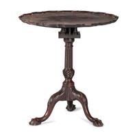 A Chippendale Carved and Figured Mahogany Pie-Crust Tilt-Top Tea Table