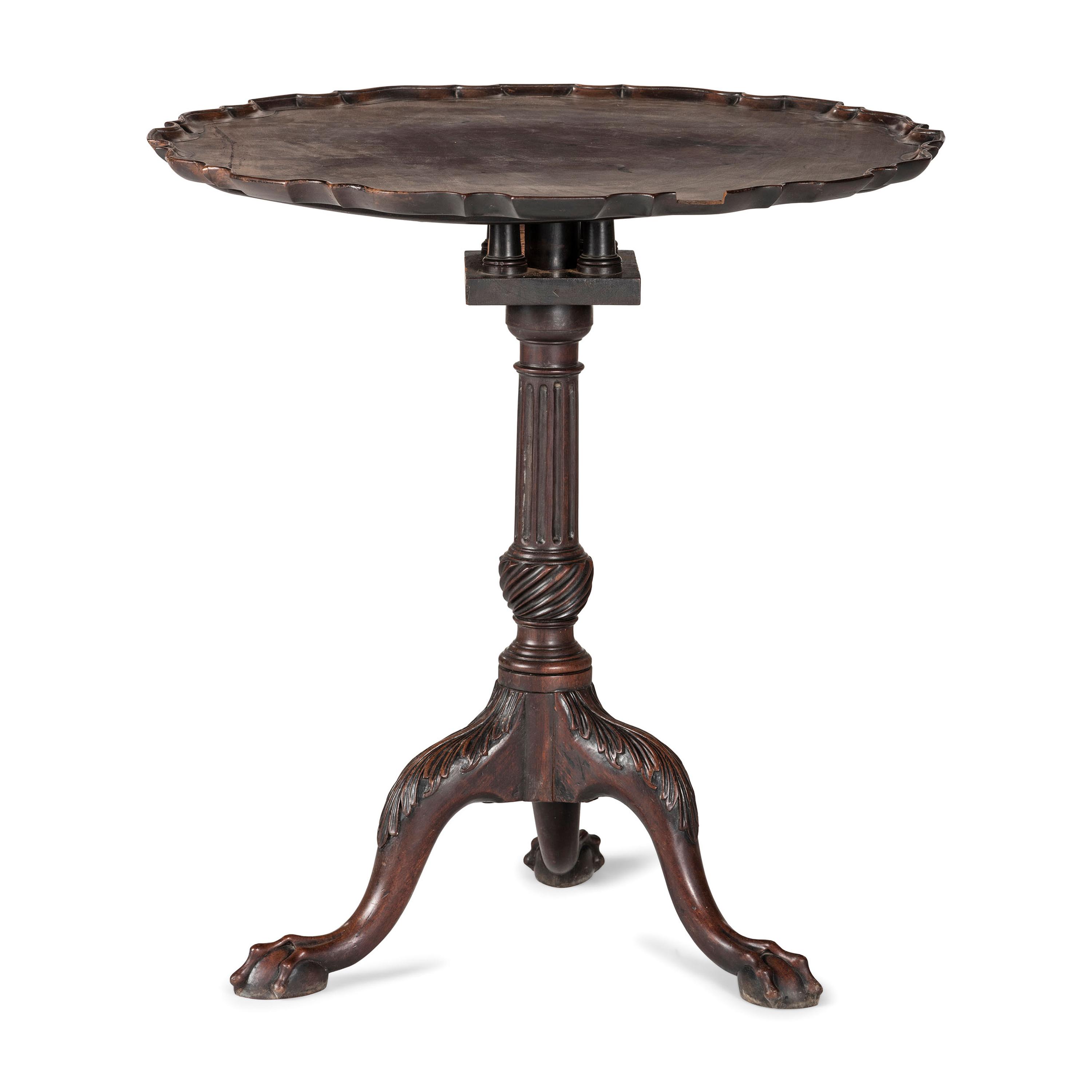 A Chippendale Carved and Figured Mahogany Pie-Crust Tilt-Top Tea Table