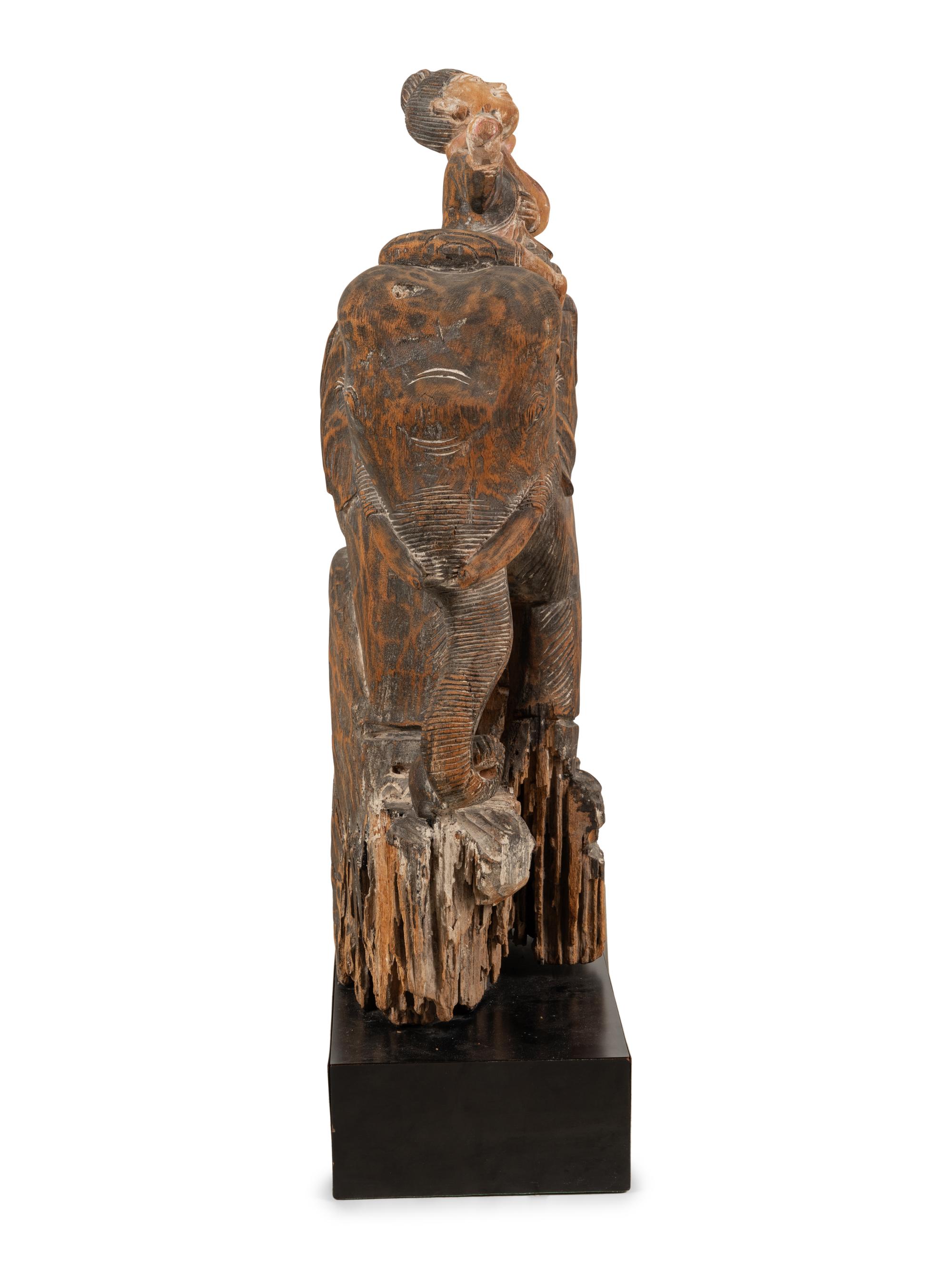 A Southeast Asian Carved and Painted Wood Group of an Elephant and Rider