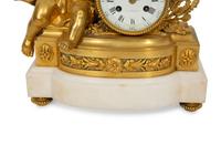 A Louis XVI Style Gilt Bronze and White Marble Mantel Clock