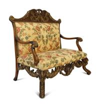 A Portuguese Carved Oak and Parcel Gilt Settee — 20TH CENTURY