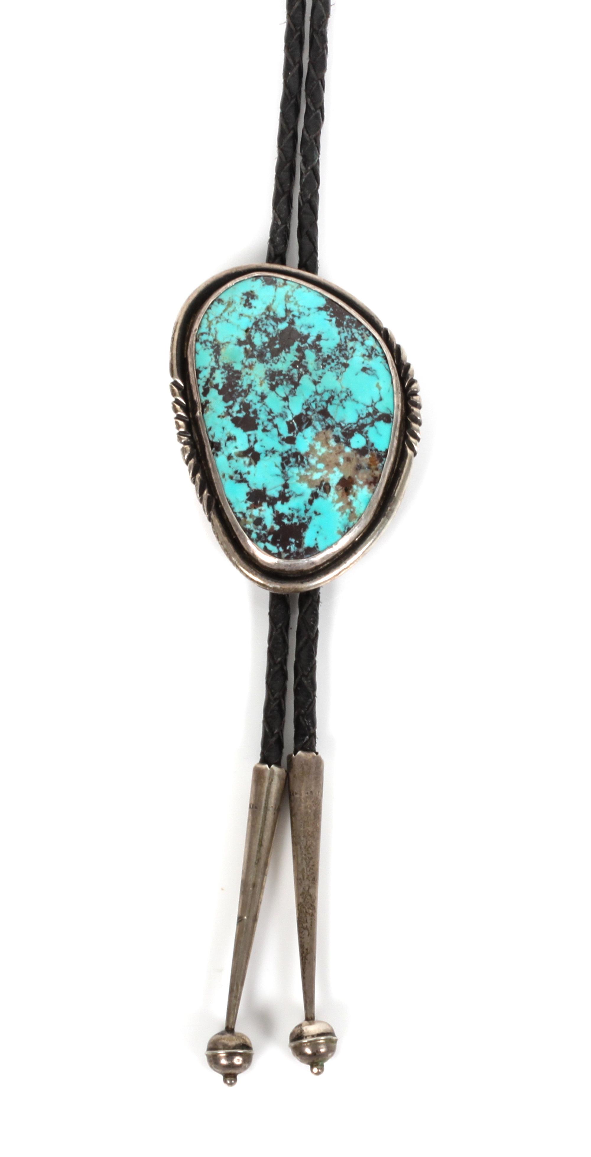 A Navajo Silver and Turquoise Bolo, Grace and Gilo Nakai Height 2 1/2 x width 1 3/4 inches.