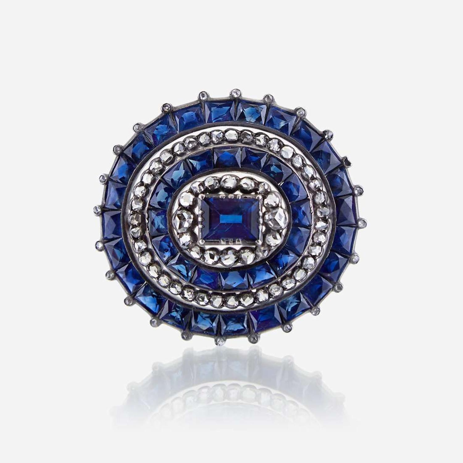 A sapphire, diamond, and silver topped eighteen karat gold brooch