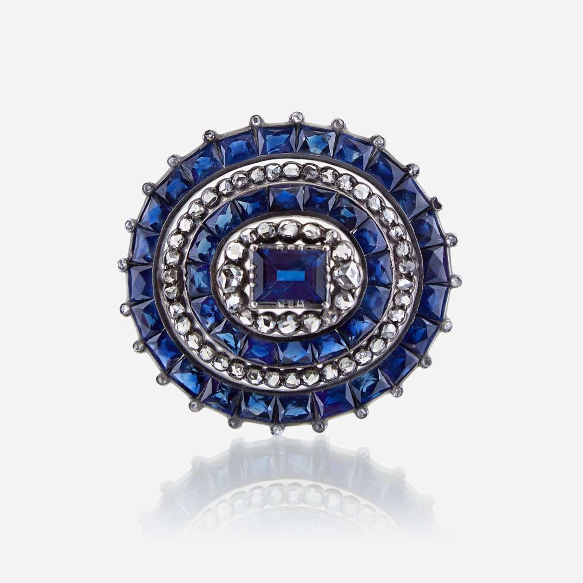 A sapphire, diamond, and silver topped eighteen karat gold brooch