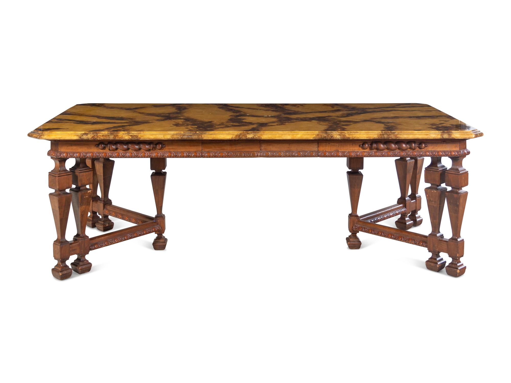 A Renaissance Revival Style Carved Walnut Faux Marble-Top Dining Table