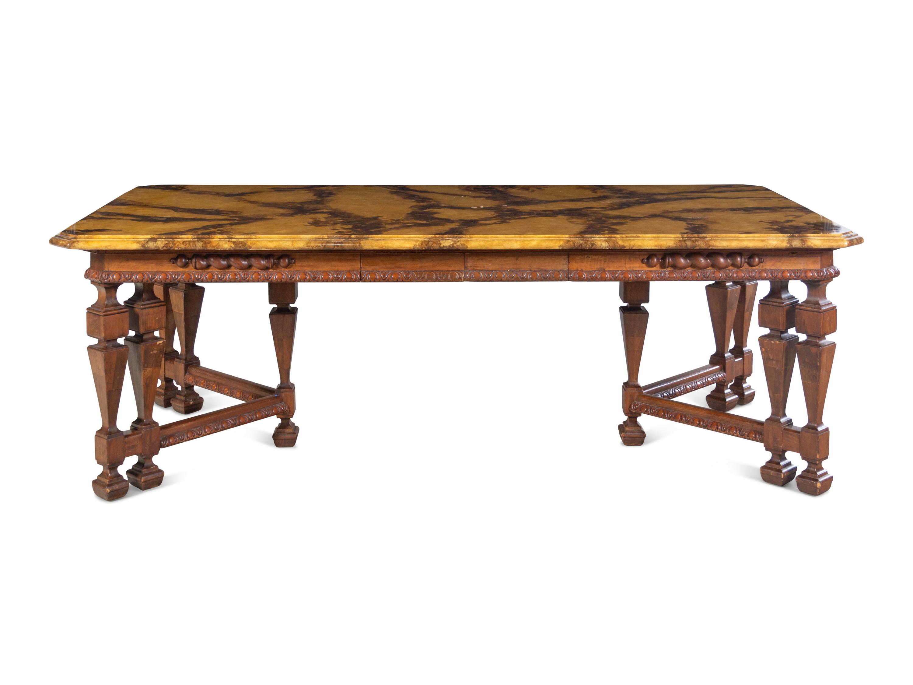 A Renaissance Revival Style Carved Walnut Faux Marble-Top Dining Table