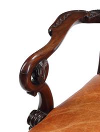 An English Carved Mahogany Leather-Upholstered Armchair