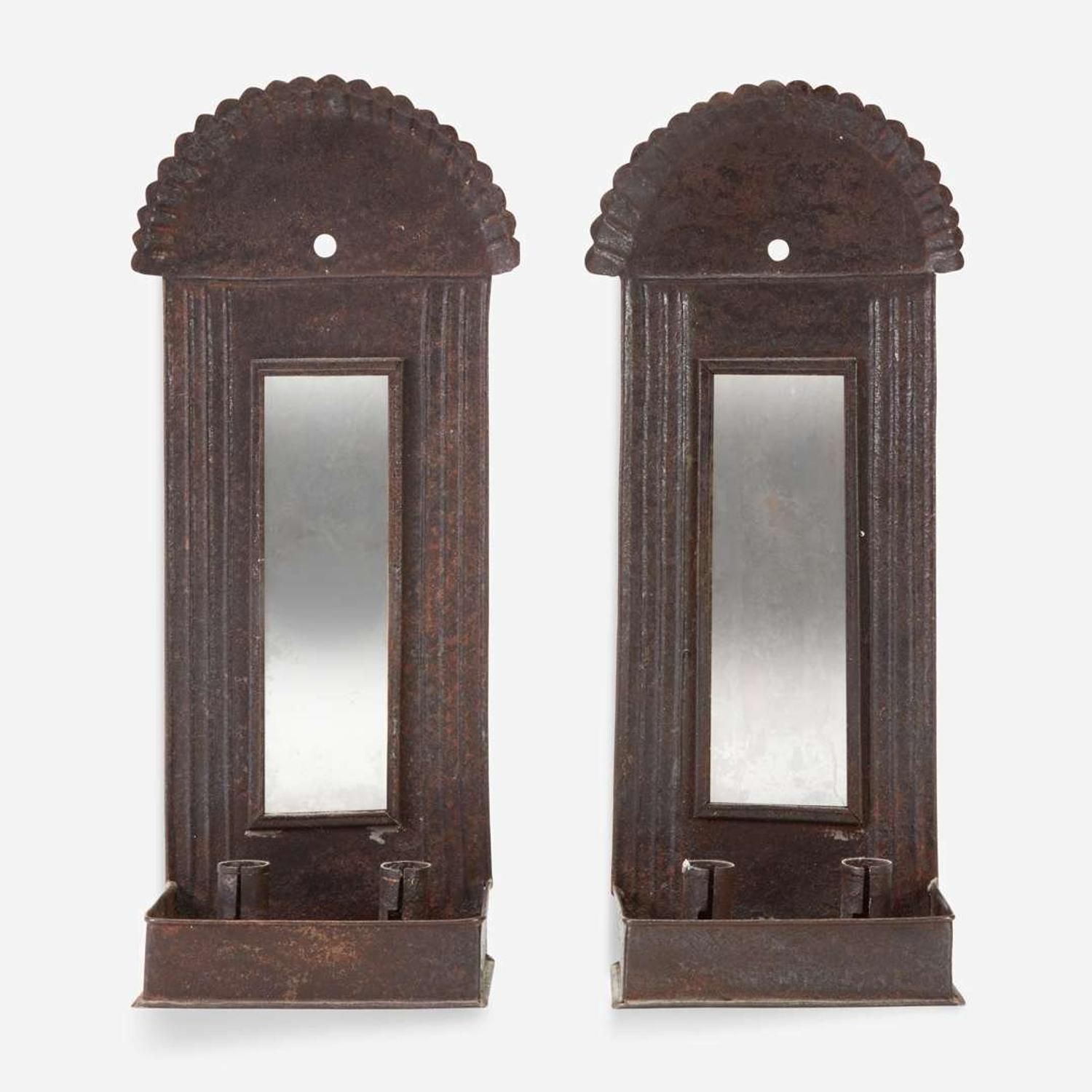 A pair of mirrored tinware candle sconces 20th century