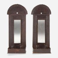 A pair of mirrored tinware candle sconces 20th century