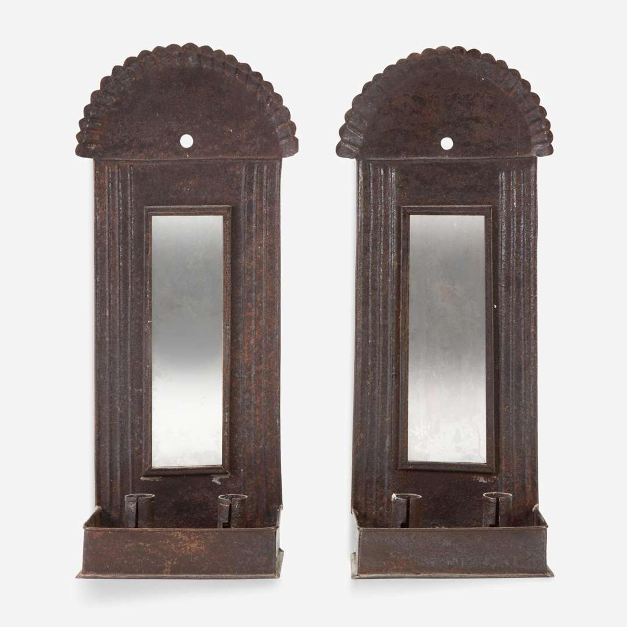 A pair of mirrored tinware candle sconces 20th century