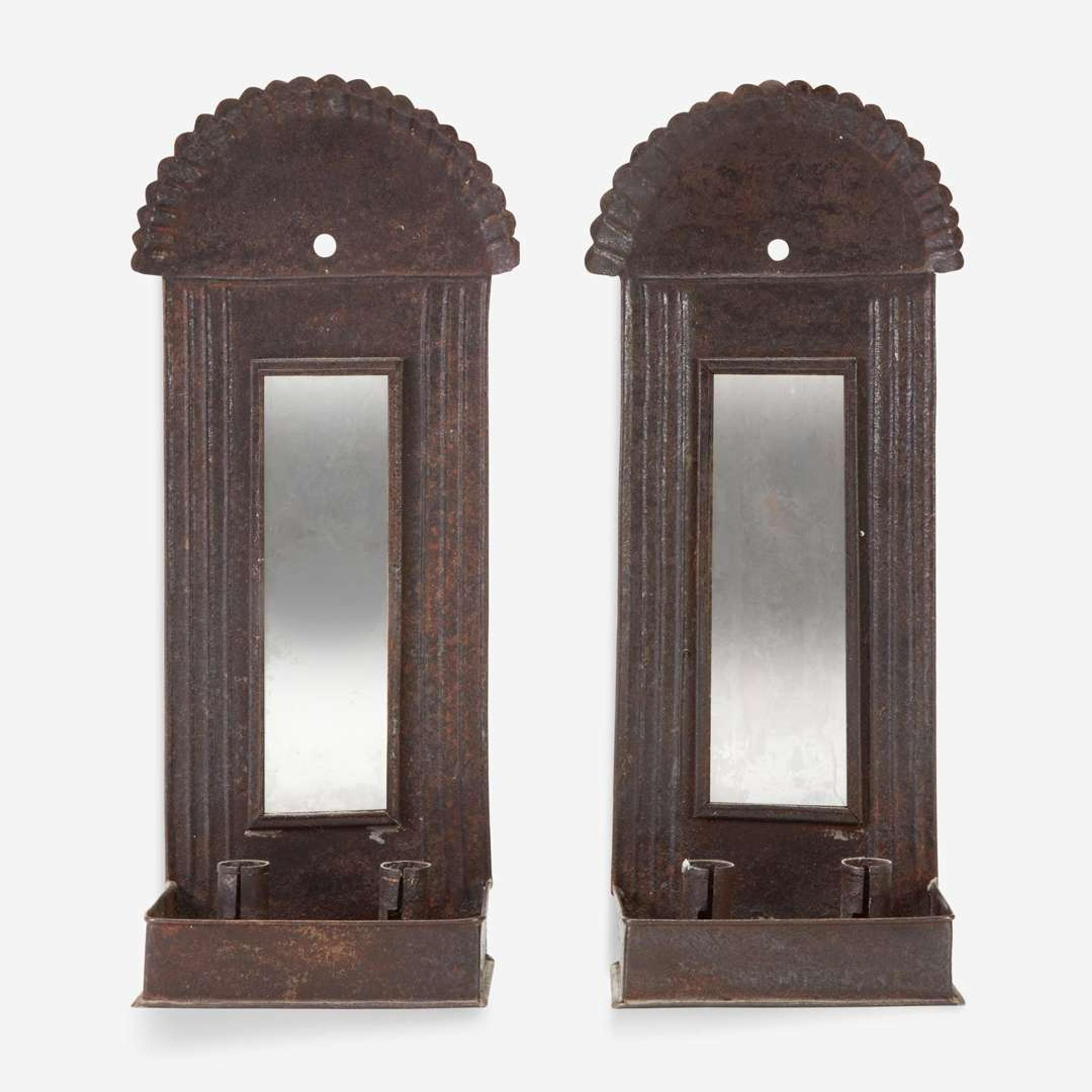 A pair of mirrored tinware candle sconces 20th century