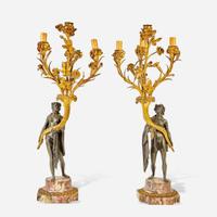 A pair of Napoleon III patinated and gilt bronze four-light figural candelabra late 19th century