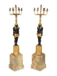 A Pair of Egyptian Revival Ebonized and Giltwood Figural Torchères
