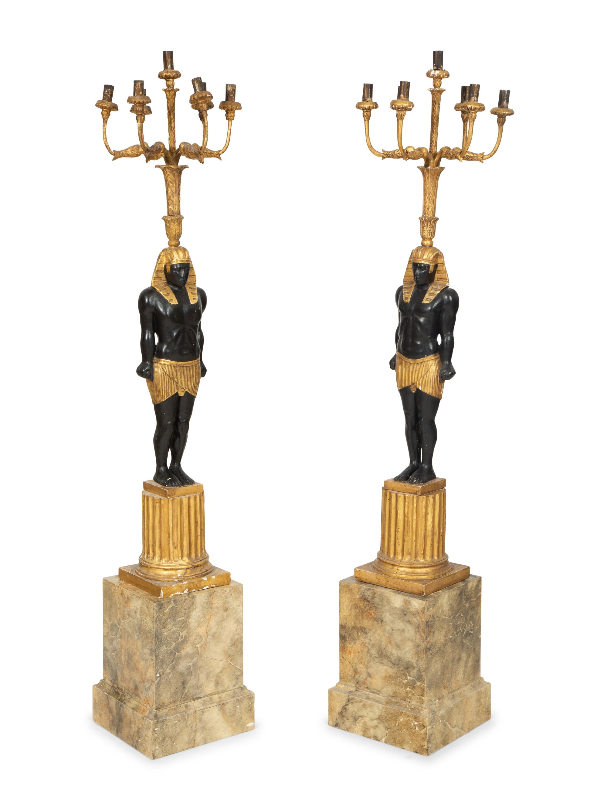 A Pair of Egyptian Revival Ebonized and Giltwood Figural Torchères