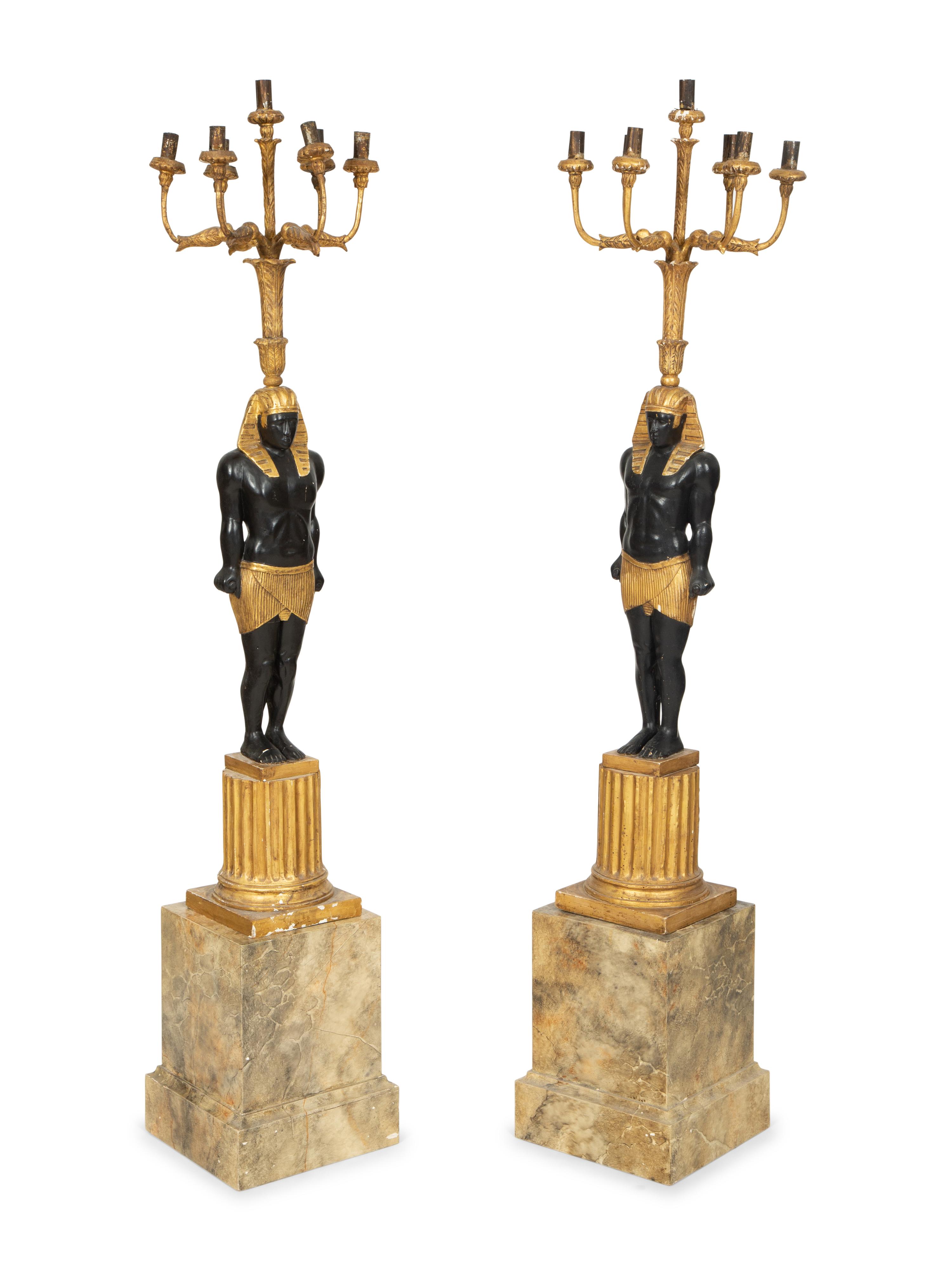 A Pair of Egyptian Revival Ebonized and Giltwood Figural Torchères