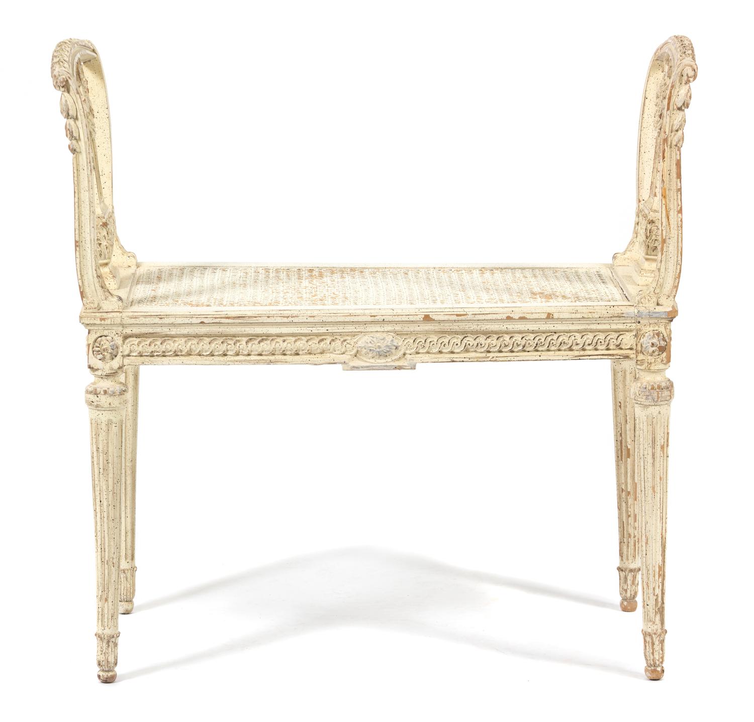 A Louis XVI Style Carved and Painted Cane Seat Window Bench Height 29 1/2 x length 30 inches. — LATE 19TH CENTURY