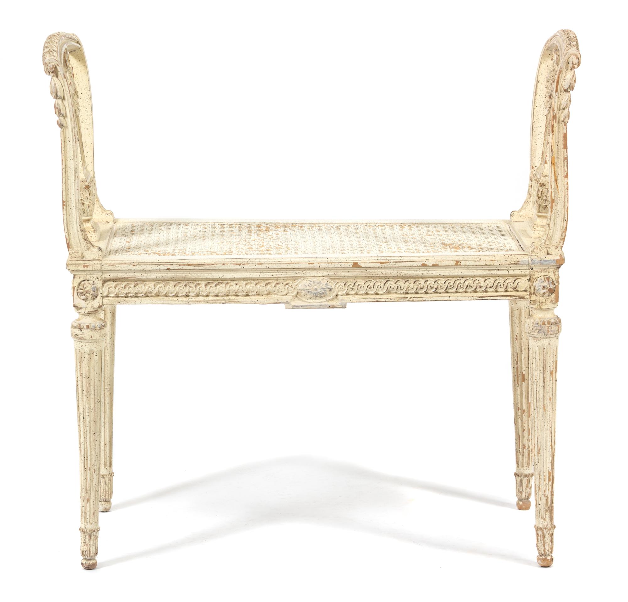 A Louis XVI Style Carved and Painted Cane Seat Window Bench Height 29 1/2 x length 30 inches. — LATE 19TH CENTURY