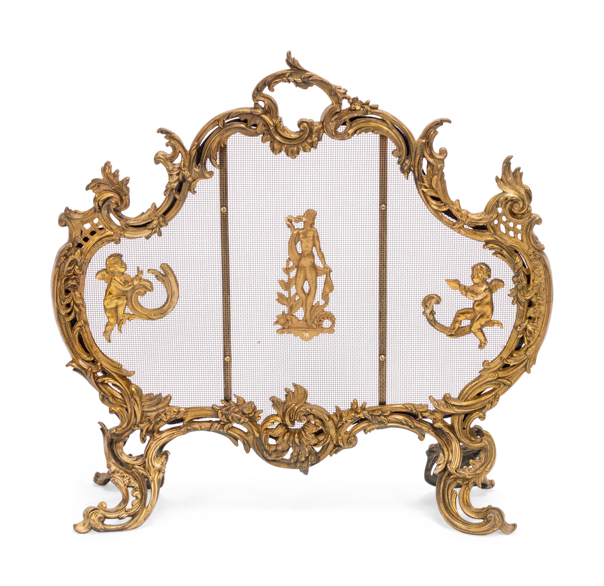 A Louis XV Style Gilt Bronze Four-Piece Fireplace Set