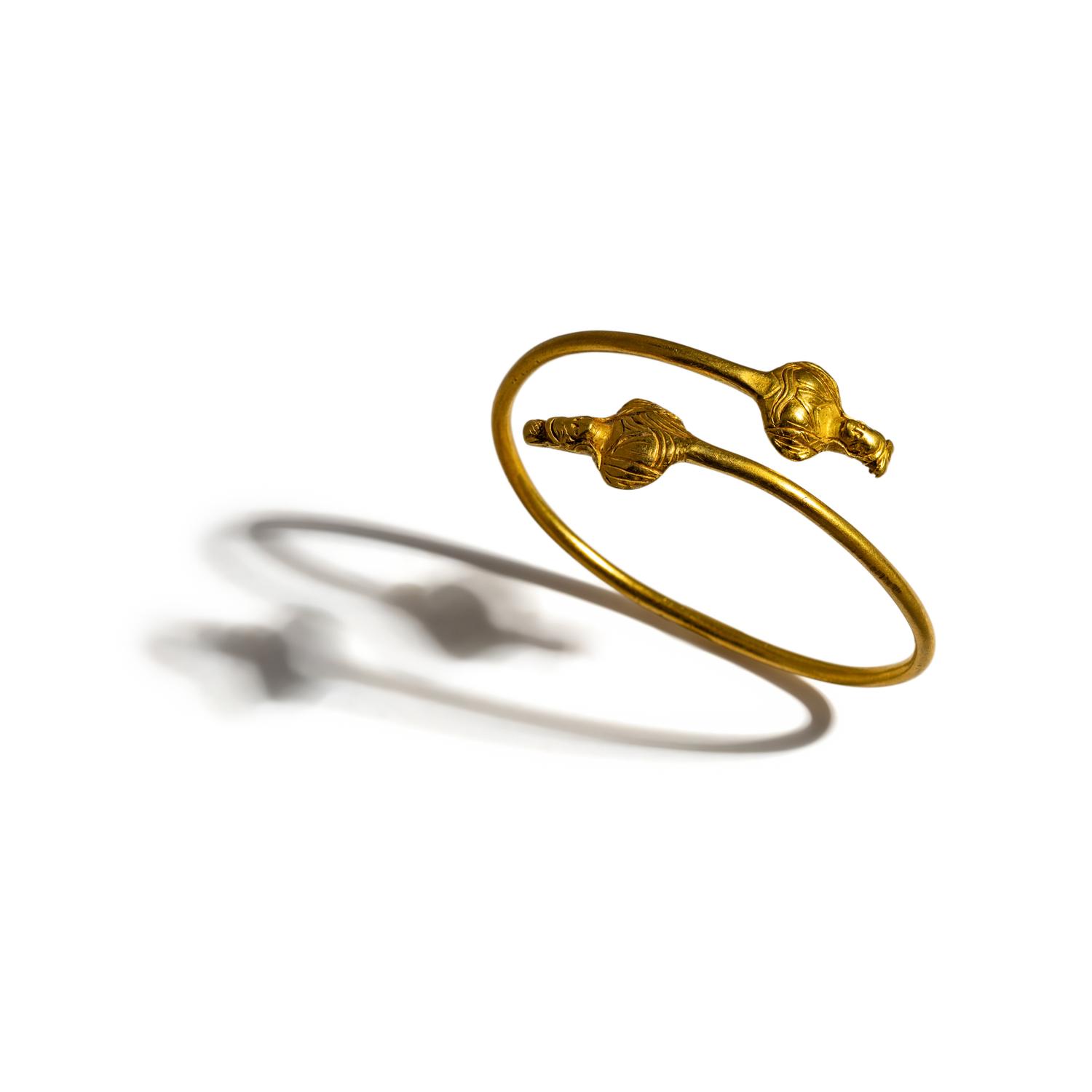 An Egyptian Gold Bracelet with Terminal Busts of the Goddess Isis
