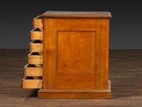 A Six-Drawer Oak Spool Cabinet