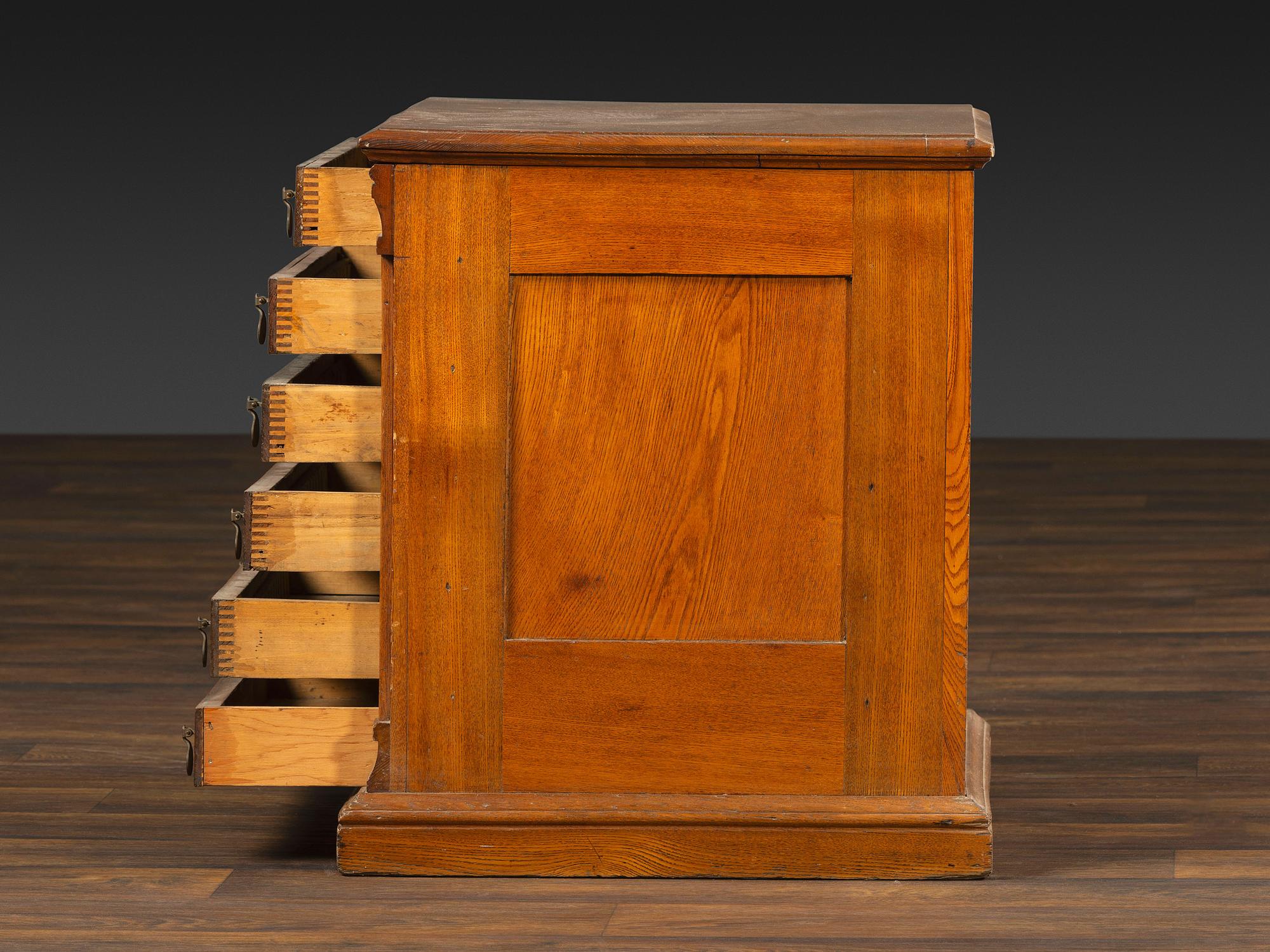 A Six-Drawer Oak Spool Cabinet