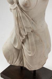 An Italian Carved White Marble Female Torso on an Iron Base