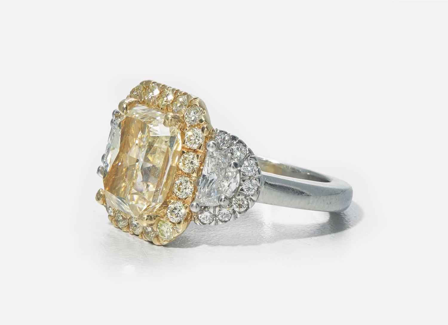 A Platinum, 18K Yellow Gold, Diamond, and 5.12 Carat Yellow Diamond Ring