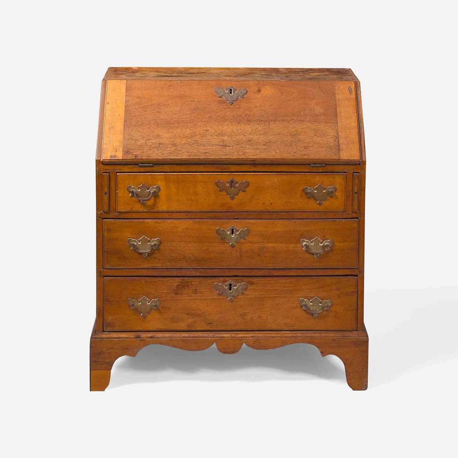 A Federal child's cherry slant-front desk together with a needlework sampler late 18th / early 19th century
