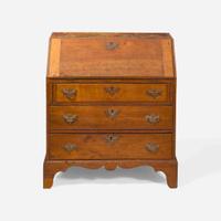 A Federal child's cherry slant-front desk together with a needlework sampler late 18th / early 19th century