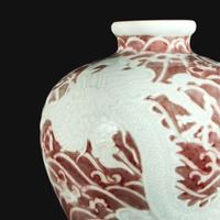 A Chinese carved and underglaze red "Dragons and Waves" vase, Meiping Yongzheng six-character mark and of the period
