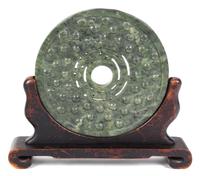 A Large Pierced and Carved Green Jadeite Roundel Height 12 inches.
