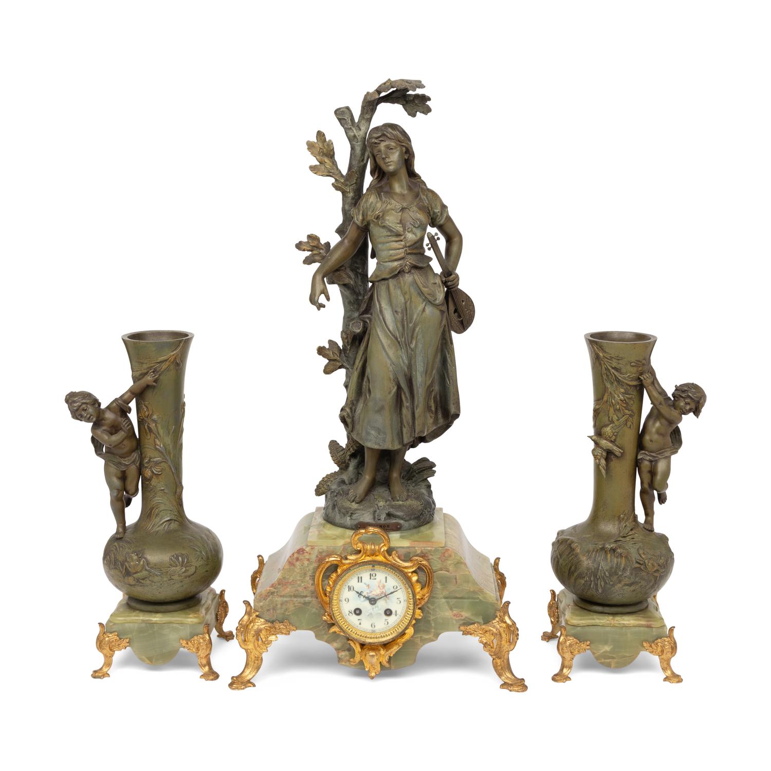 A French Patinated Cast Metal and Onyx Clock Garniture