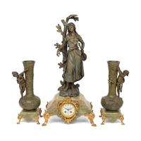 A French Patinated Cast Metal and Onyx Clock Garniture