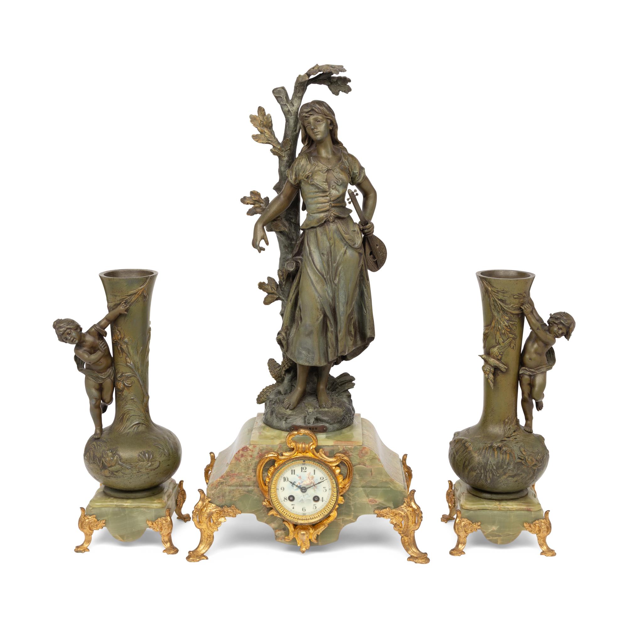 A French Patinated Cast Metal and Onyx Clock Garniture