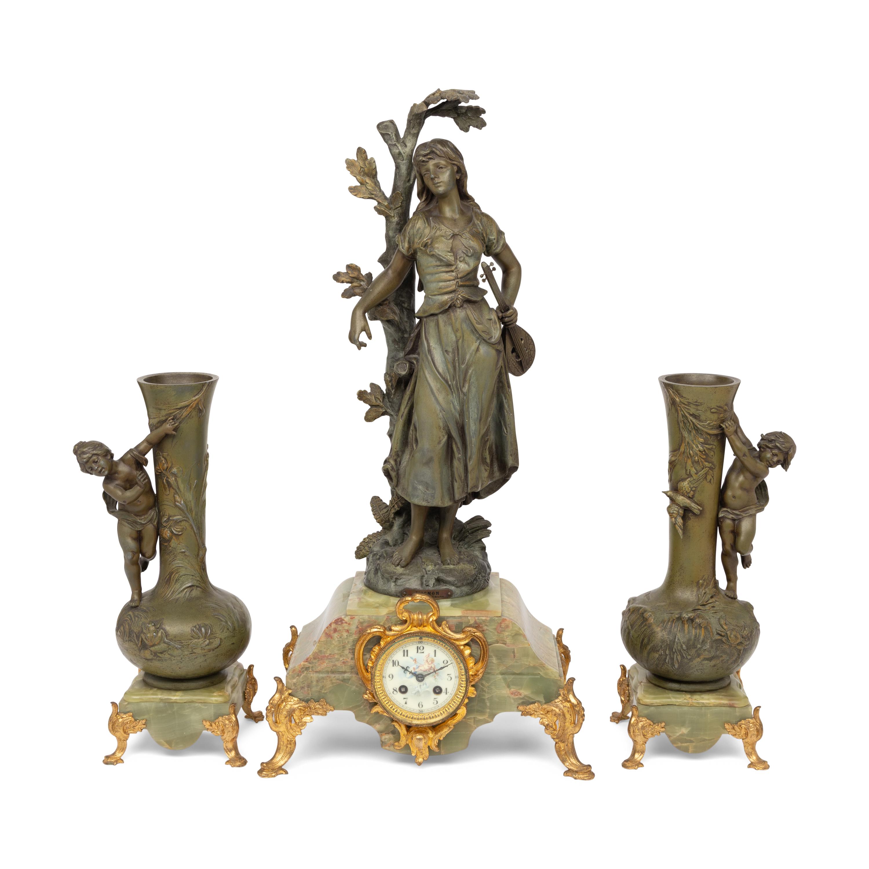 A French Patinated Cast Metal and Onyx Clock Garniture